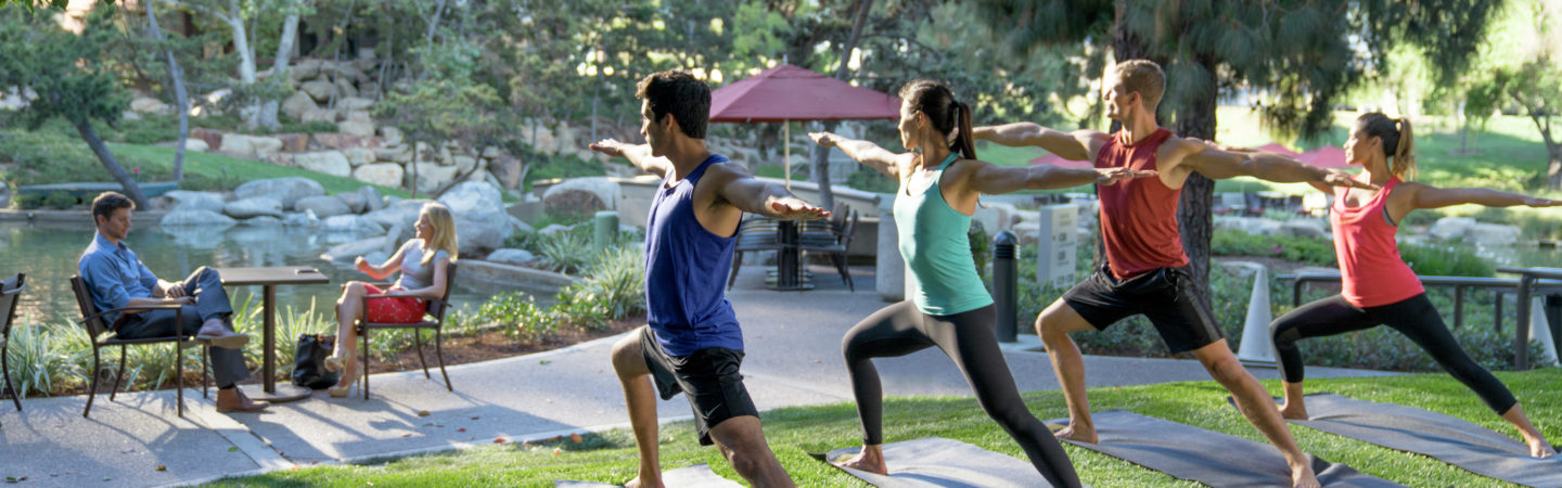 A group of men and women doing yoga at The Plaza, 4350 La Jolla Village Drive in San Diego, CA