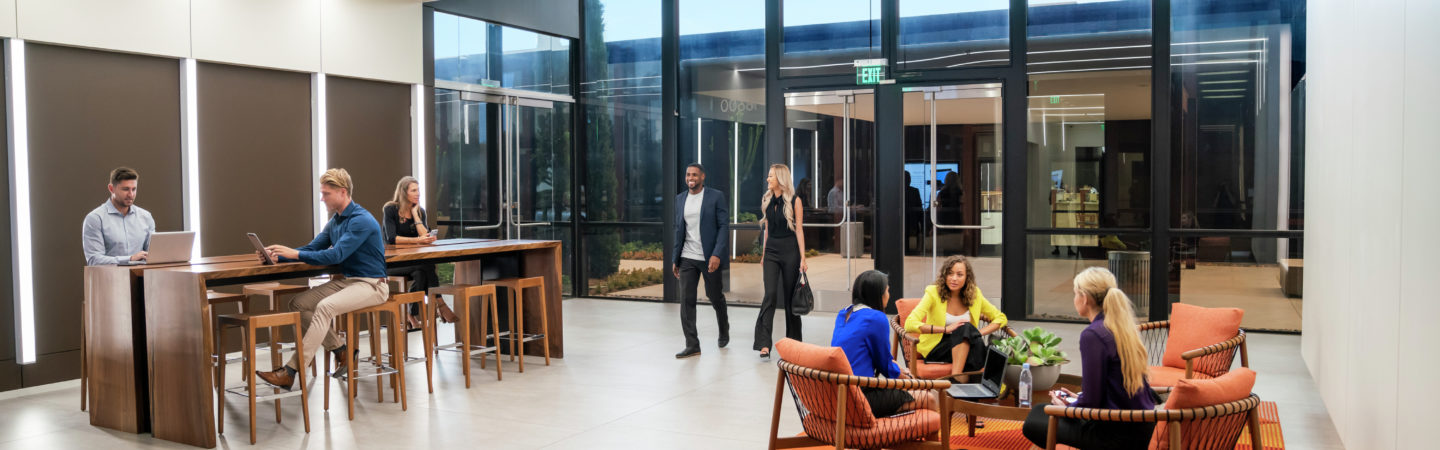 Businesspeople enjoying the workspace and seating areas in the lobby of The Launch office building lobby in Irvine, CA