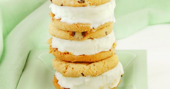 Chocolate chip cookie with vanilla ice cream sandwich on a mint green plate
