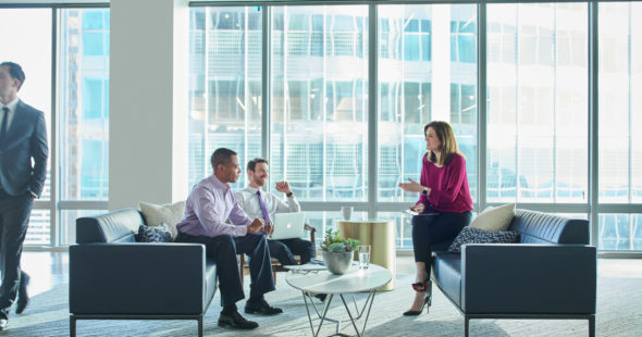 Business people having a conversation inside 71 South Wacker in Chicago, IL