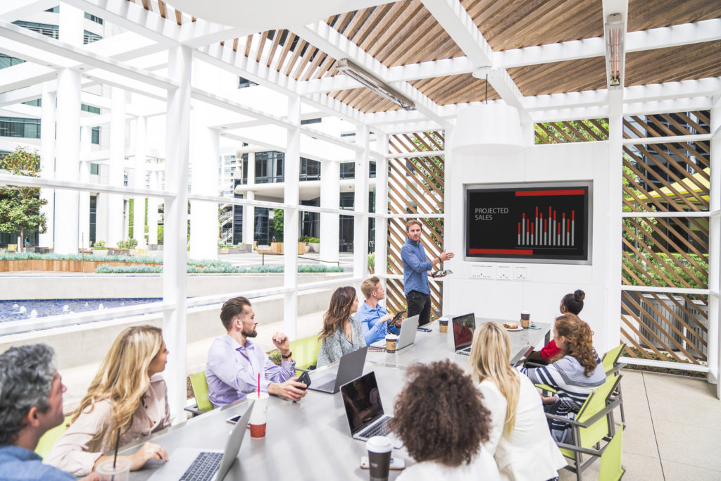 Photography of people enjoying The Commons, an outdoor workplace and gathering area, at Irvine Towers in Irvine, CA