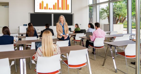Photography of businesspeople sitting at a conference center while the presenter is speaking at 400 Spectrum Center in Irvine, CA
