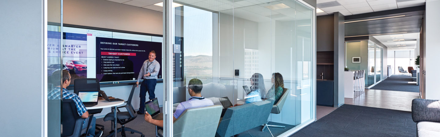 Office suite interior photography of Mazda employees meeting in a conference room