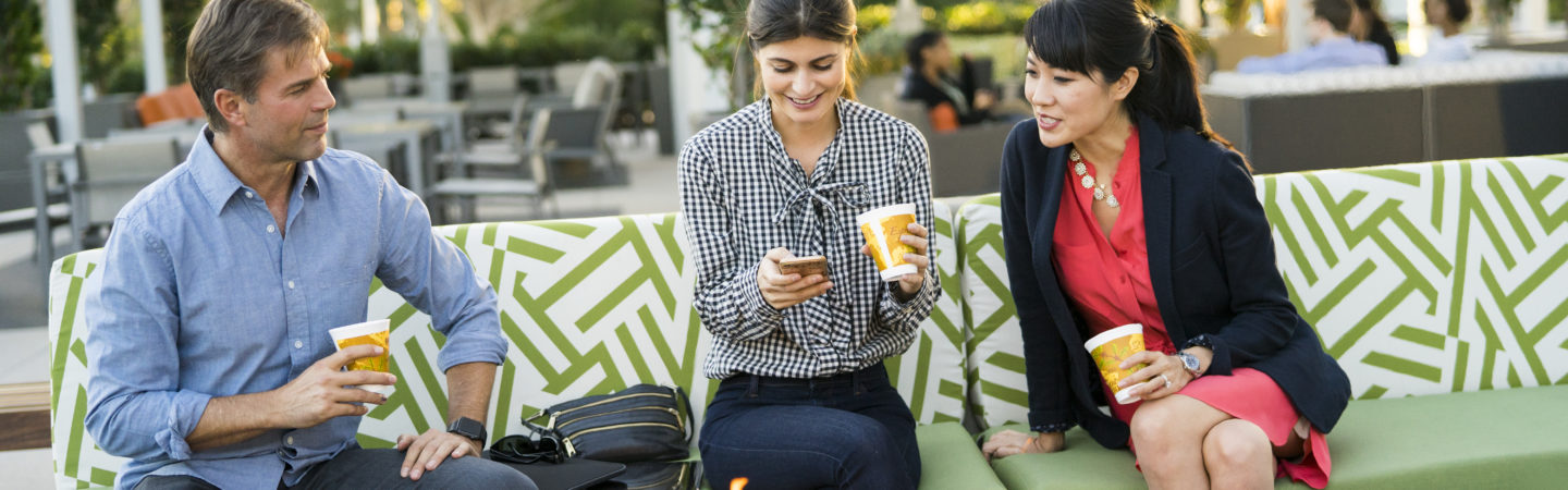 Photography of people enjoying The Commons, an outdoor workplace and gathering area, at 400 Spectrum Center Drive in Irvine, CA