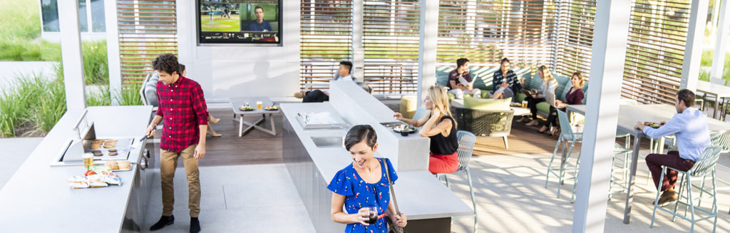 Photography of people enjoying The Commons, an outdoor workplace and gathering area, at The Quad at Discovery Park in Irvine, CA
