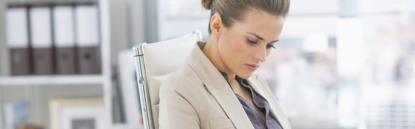 Businesswoman reviewing a report at her desk