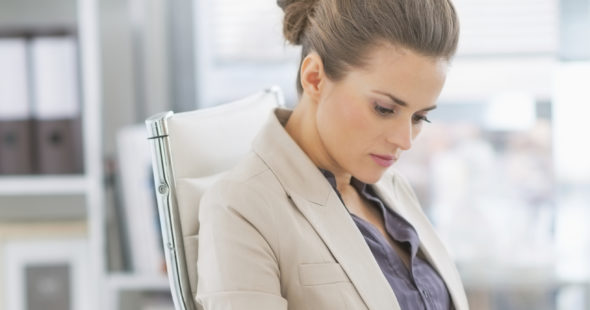 Businesswoman reviewing a report at her desk