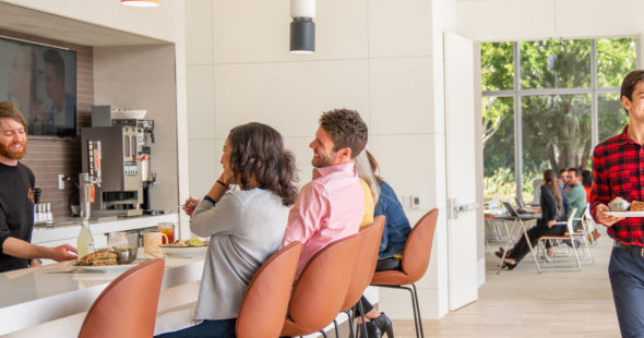 Photography of customers enjoying The Patio Marketplace, a cafe and restaurant located on-site at 400 Spectrum Center Drive in Irvine, CA