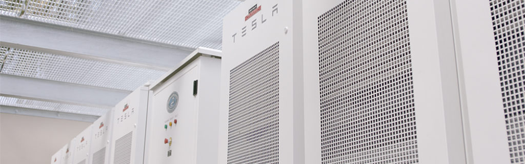 Photography of Tesla batteries used to power hybrid electric office buildings