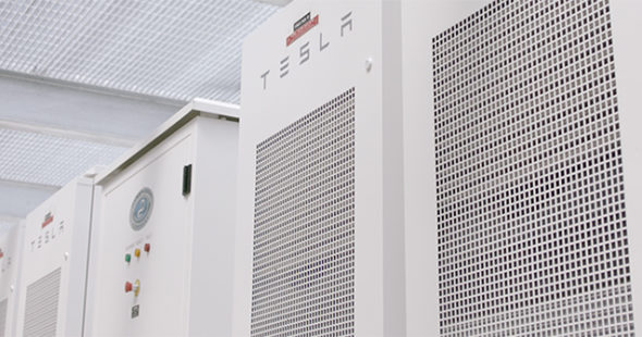 Photography of Tesla batteries used to power hybrid electric office buildings