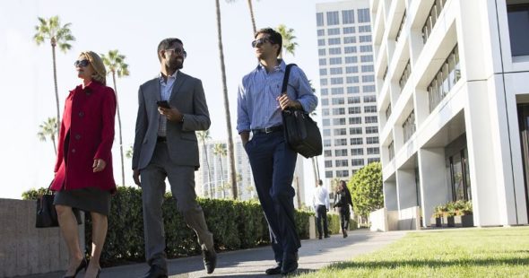 Buisnesspeople walking outside near Newport Center Irvine Company Office buildings in Newport Beach, CA