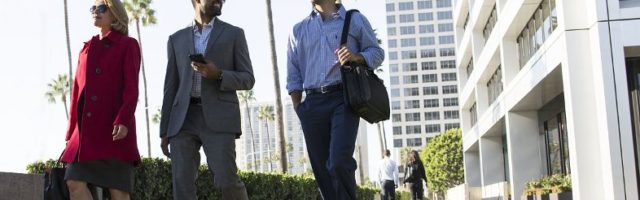 Buisnesspeople walking outside near Newport Center Irvine Company Office buildings in Newport Beach, CA