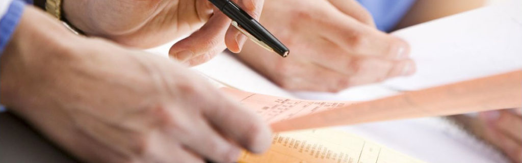 Photography of a doctor reviewing paperwork with his assistant