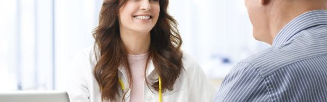 Female doctor speaking with an older man