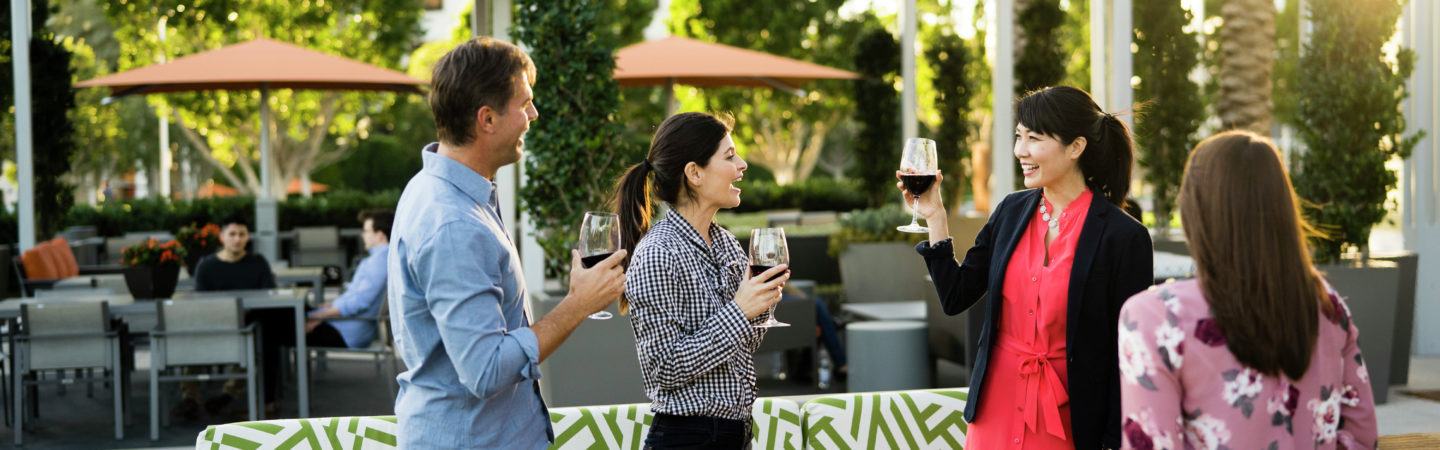 Photography of people enjoying The Commons, an outdoor workplace and gathering area, at 400 Spectrum Center in Irvine, CA