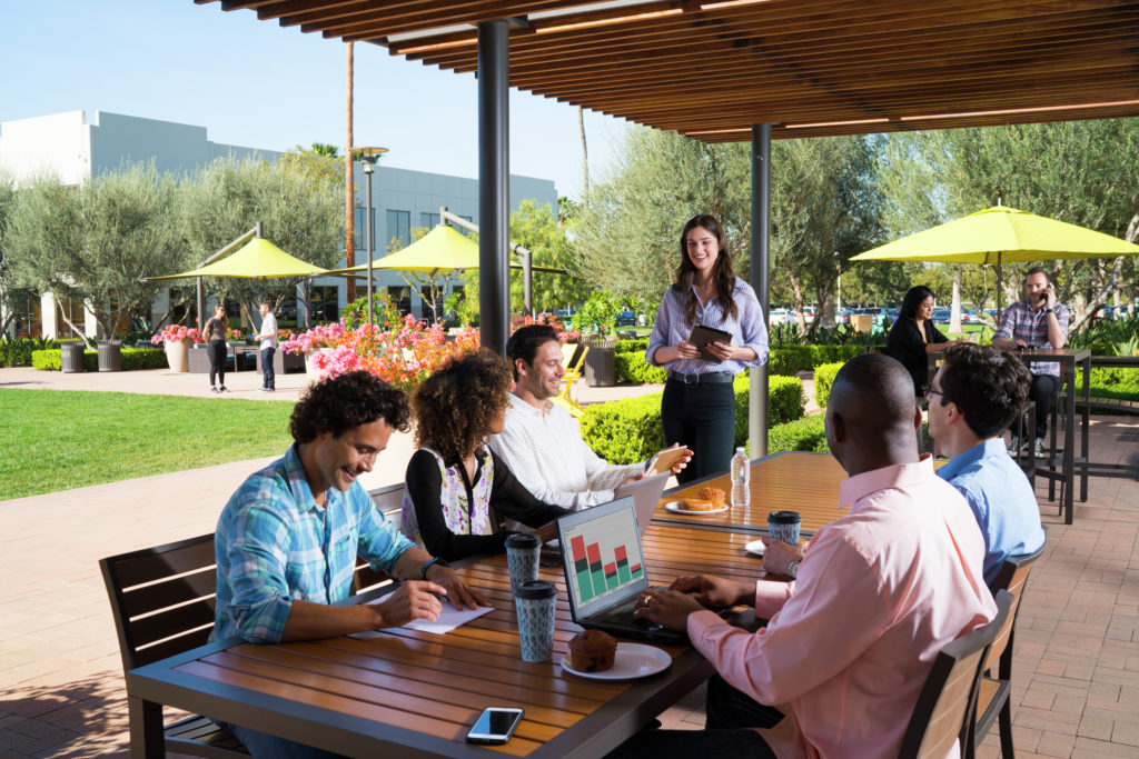 Photography of people enjoying The Commons, an outdoor workplace and gathering area, at Discovery Park in Irvine, CA