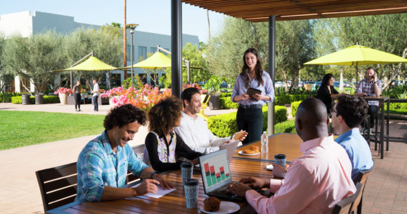 Photography of people enjoying The Commons, an outdoor workplace and gathering area, at Discovery Park in Irvine, CA