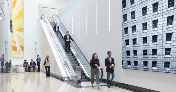 Photo of the digital media wall and people going down the escalator at The Exchange in 71 South Wacker, Chicago, IL