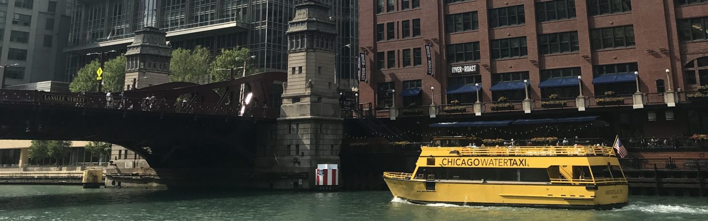 Photography of the Wendella Water Taxi on the river by 300 North LaSalle in Chicago, IL