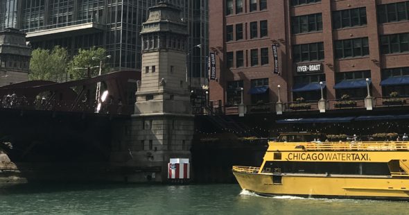Photography of the Wendella Water Taxi on the river by 300 North LaSalle in Chicago, IL