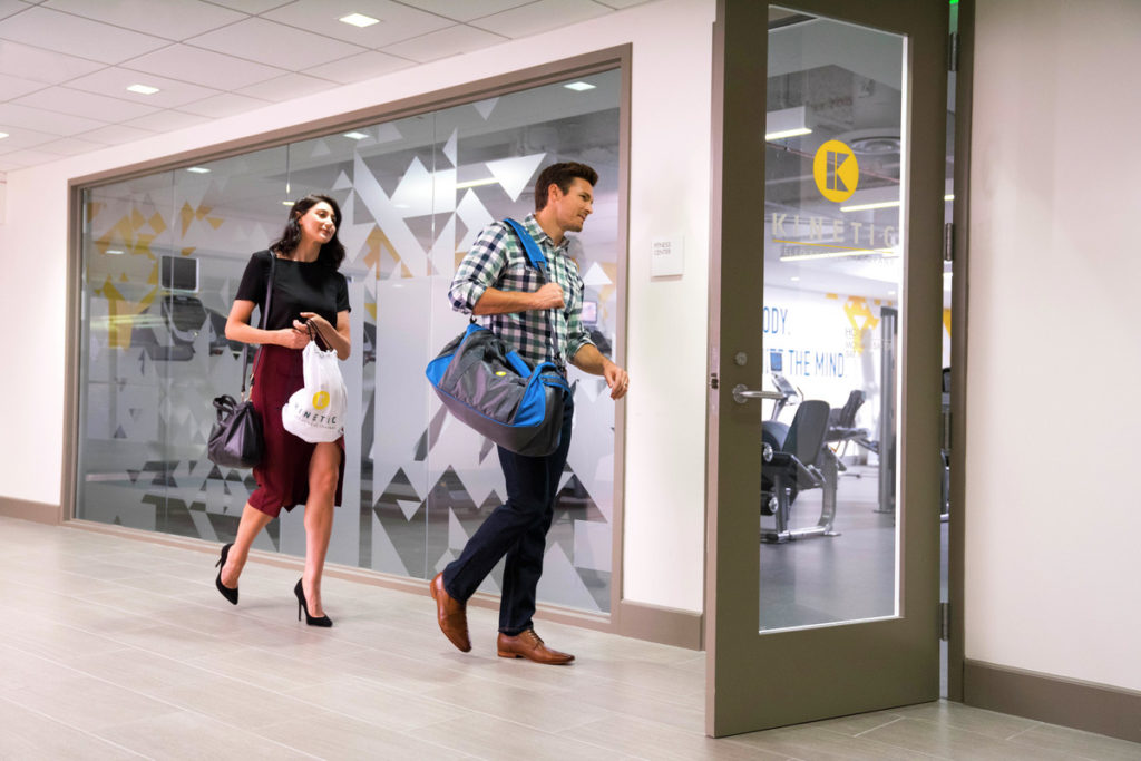 Lifestyle photography of the entrance to a KINETIC fitness center