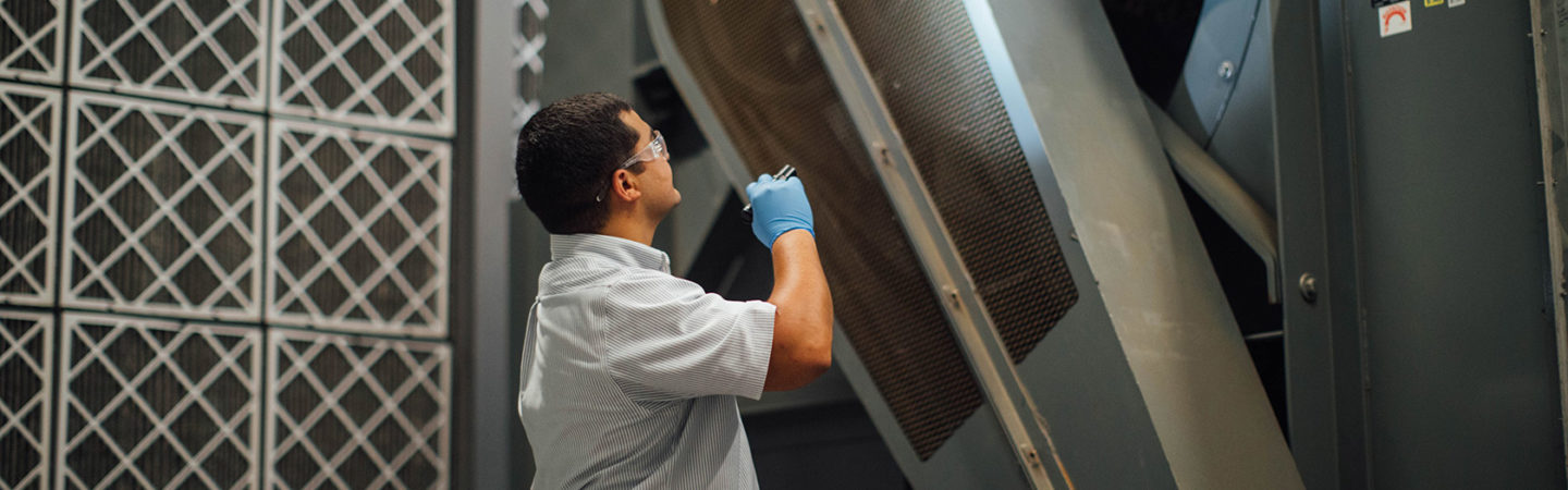 Engineer inspecting ventilation and filtration systems